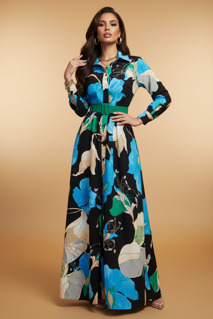 Person wearing a colorful floral dress standing outdoors near a brick building.