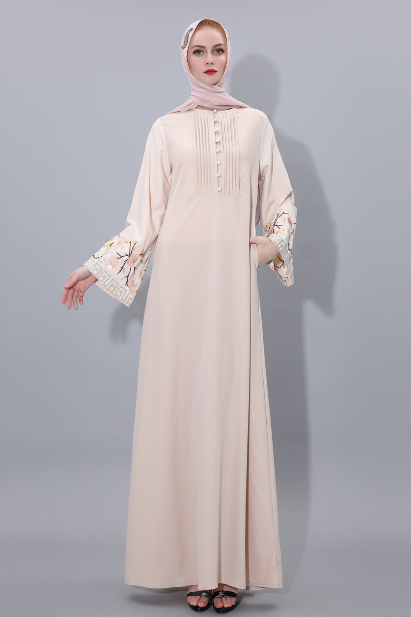 Beige abaya with floral cuffs on a white background