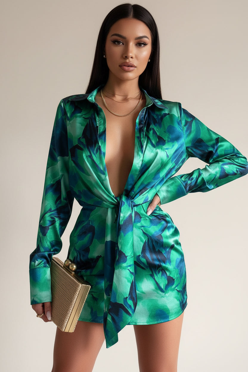 Green and blue patterned dress with a plunging neckline on a plain background