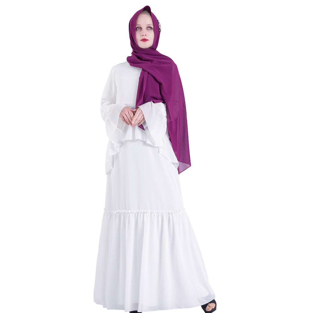 Woman wearing a white dress and purple hijab on a white background
