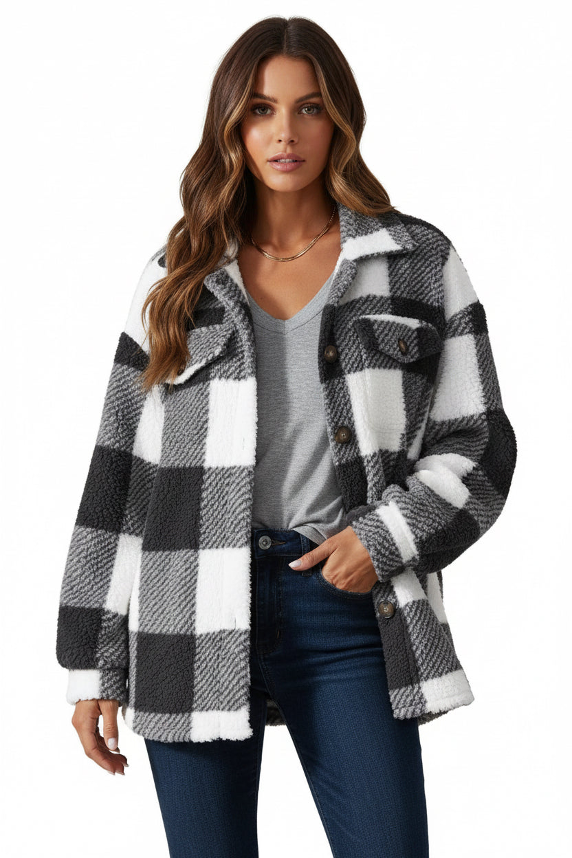Person wearing a black and white checkered cardigan on a white background