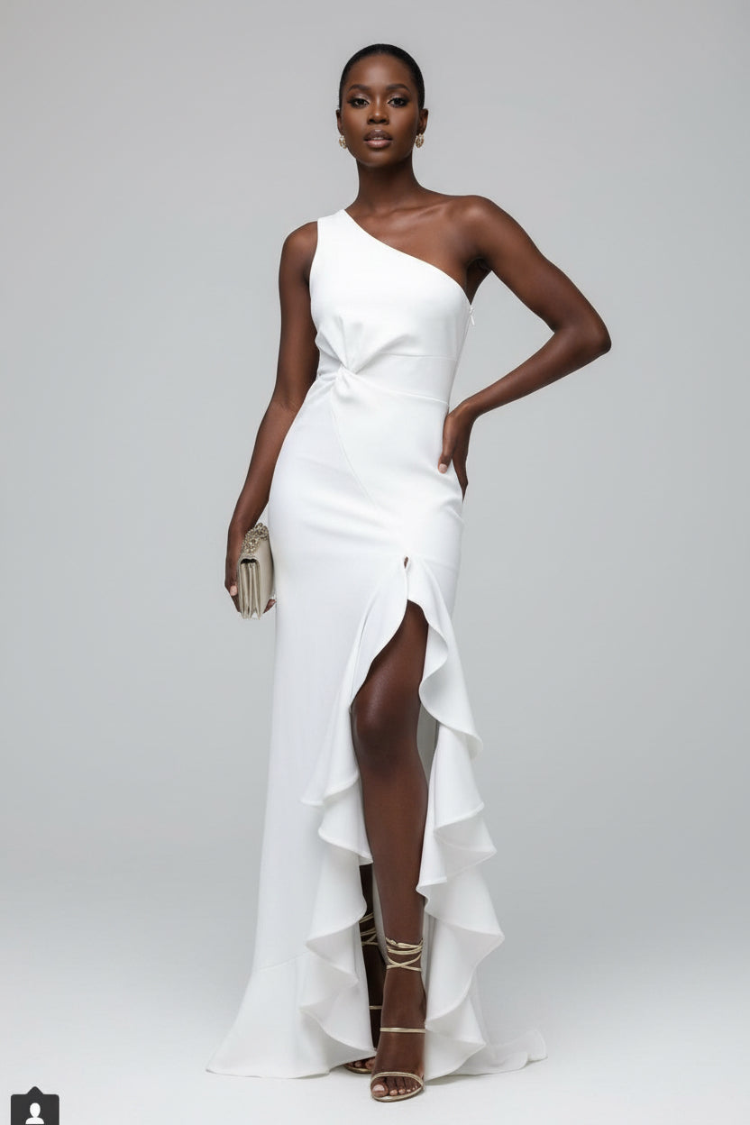 Woman in a white one-shoulder dress standing on a staircase.