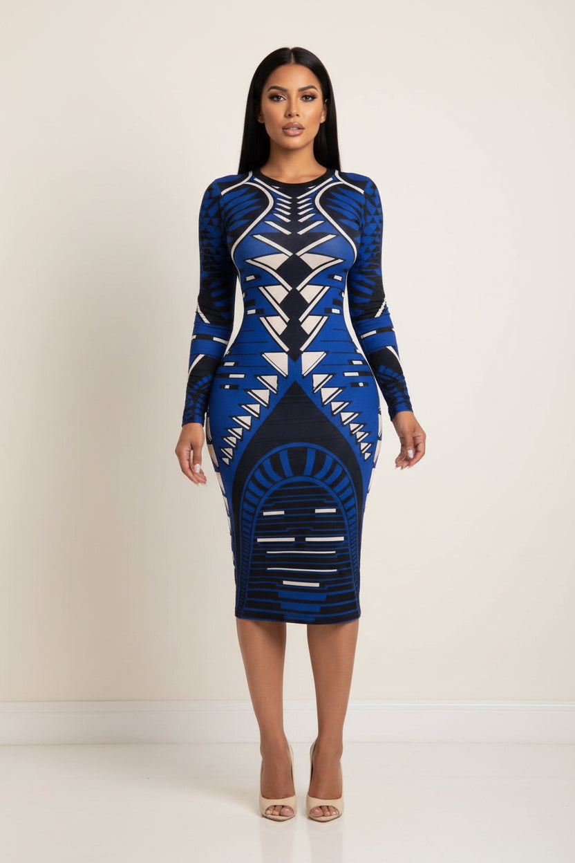 Blue and black patterned dress worn by a model in front of a mirror.