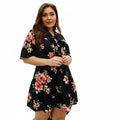 Woman wearing a black floral dress on a white background