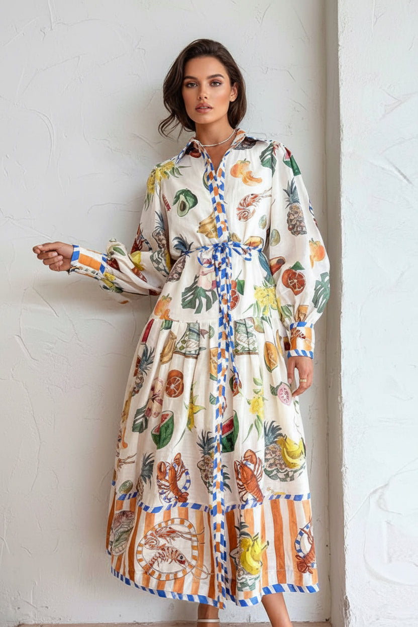 Person wearing a colorful patterned dress against a white wall