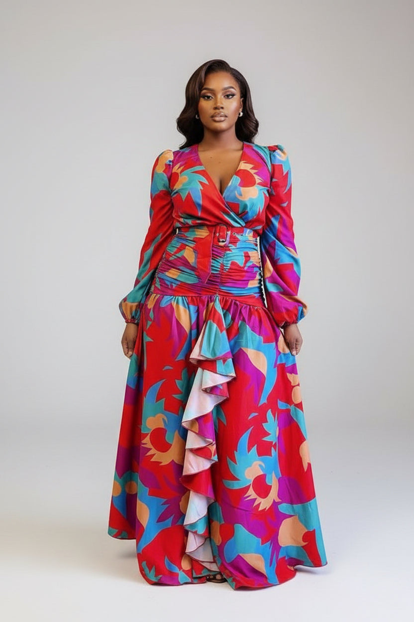 Person wearing a colorful floral dress standing in front of leopard print curtains.