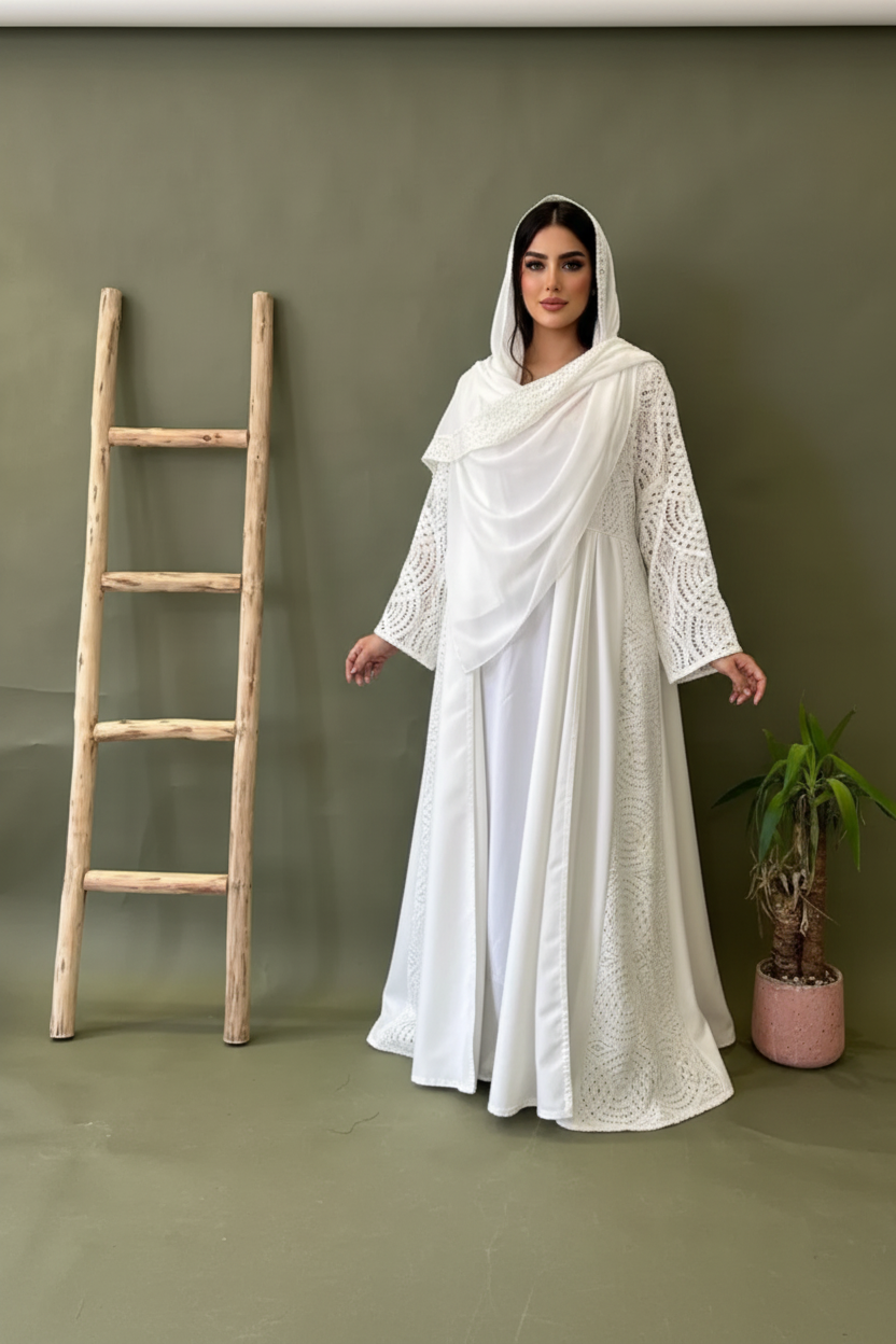 Person in a white dress holding a newspaper over their face against a green background with a wooden ladder and plant.