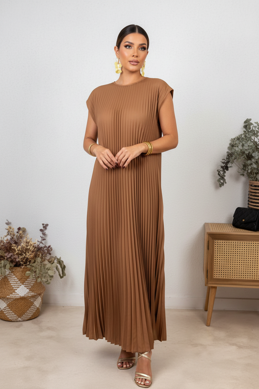 Person wearing a brown pleated dress taking a mirror selfie.