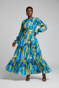Person wearing a colorful geometric patterned dress on a white background