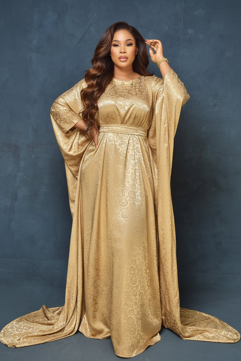 Woman wearing a gold dress against a gray background
