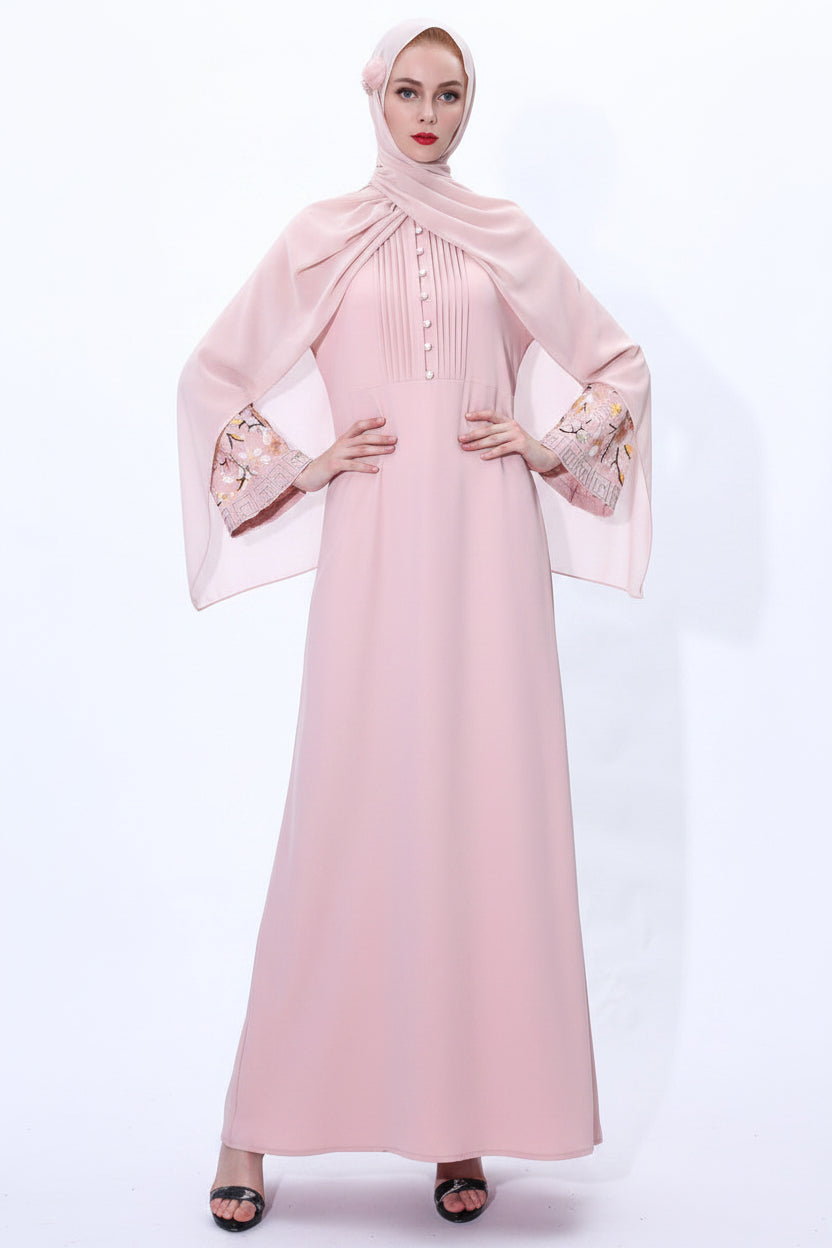 Woman wearing a pink abaya and hijab on a white background