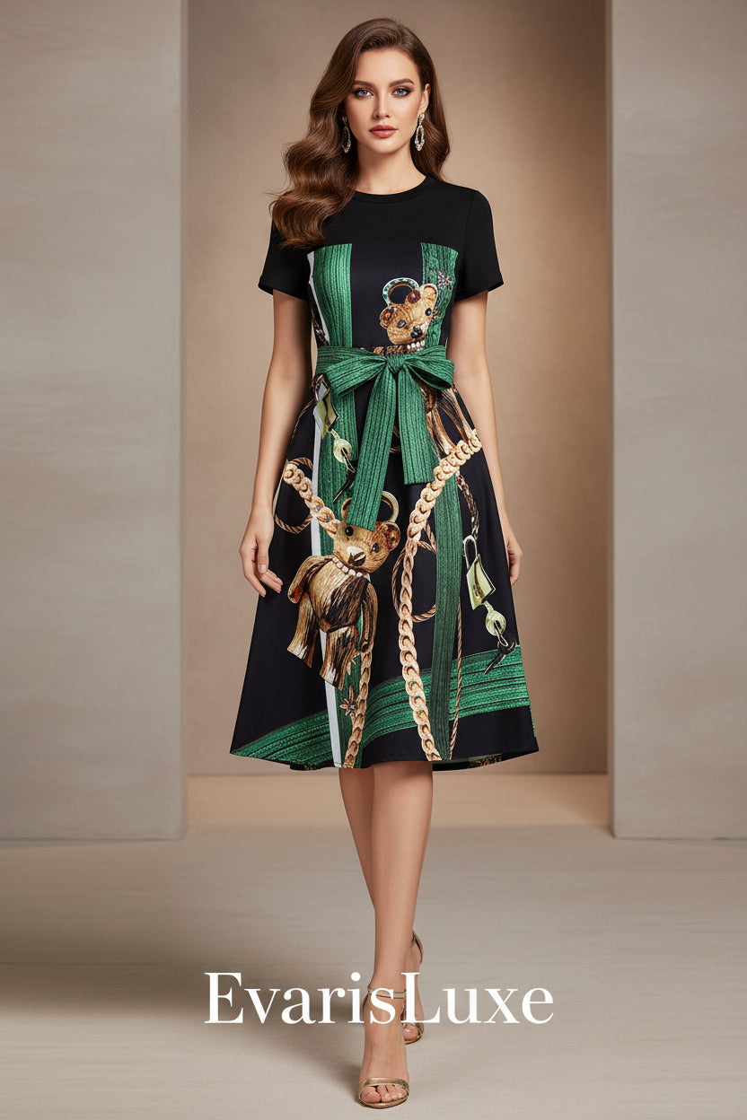 Black dress with green belt and animal print on a white background