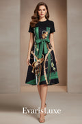 Black dress with green belt and animal print on a white background