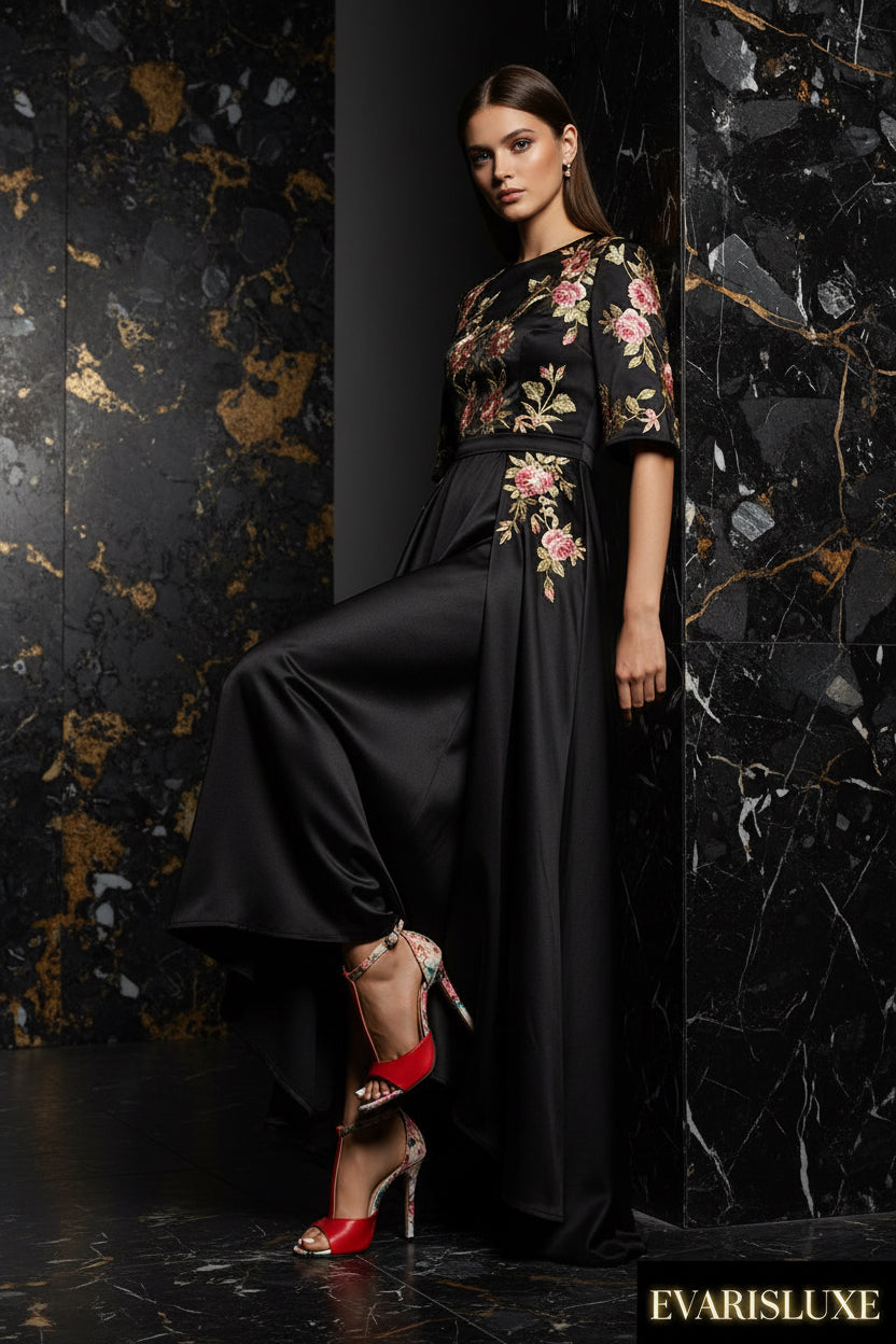Red high-heeled shoes with floral straps worn by a person on a light background
