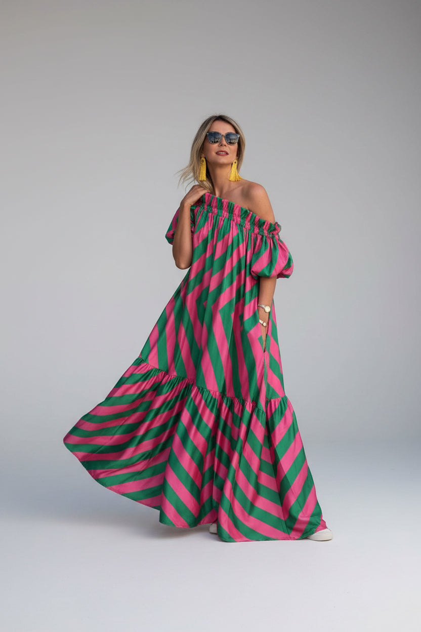 Woman wearing a pink and green striped dress on a white background