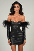Black leather dress with feathered shoulders on a plain background