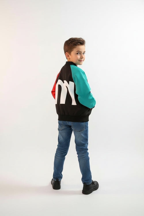 Colorful jacket with a large white letter 'm' on a textured surface