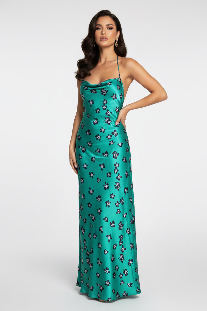 Teal dress with floral pattern on a mannequin against a white background