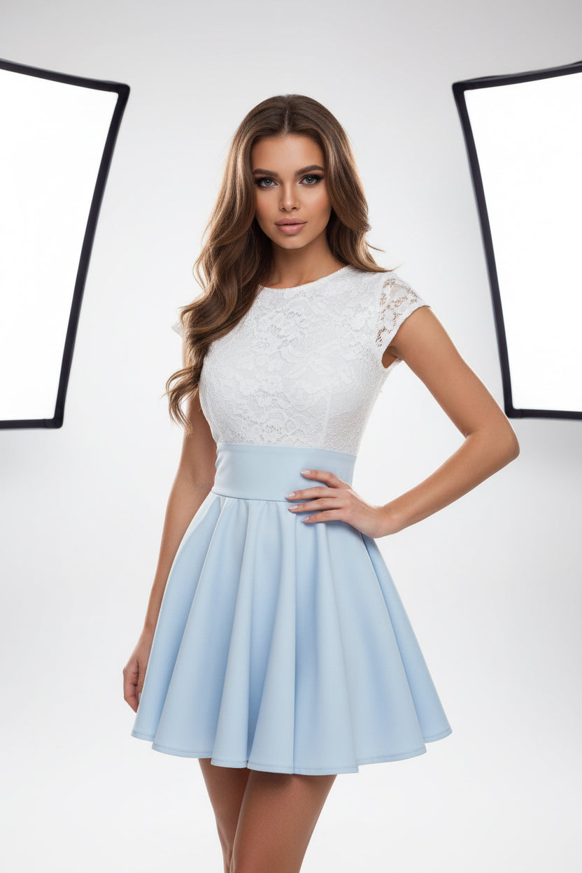 Woman taking a mirror selfie wearing a white top and light blue skirt.