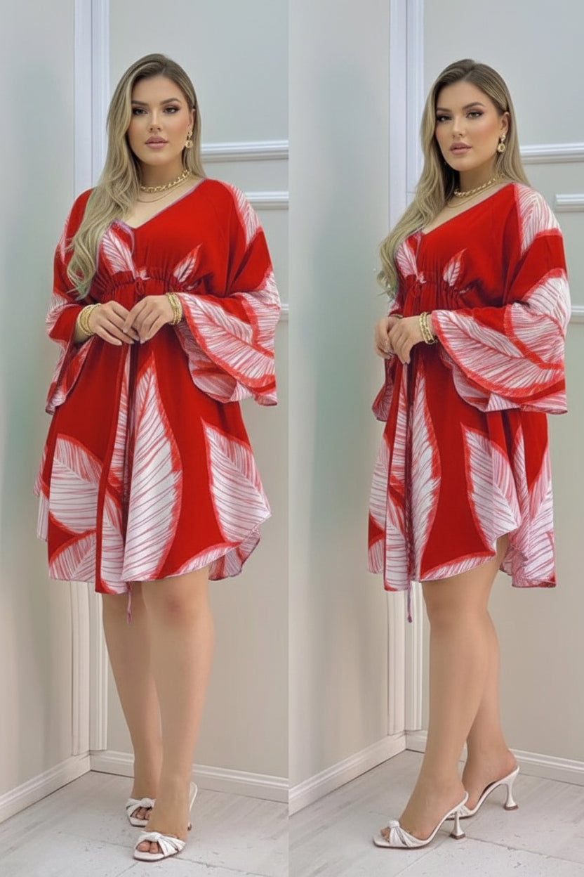 Red and white patterned dress worn by a person indoors.