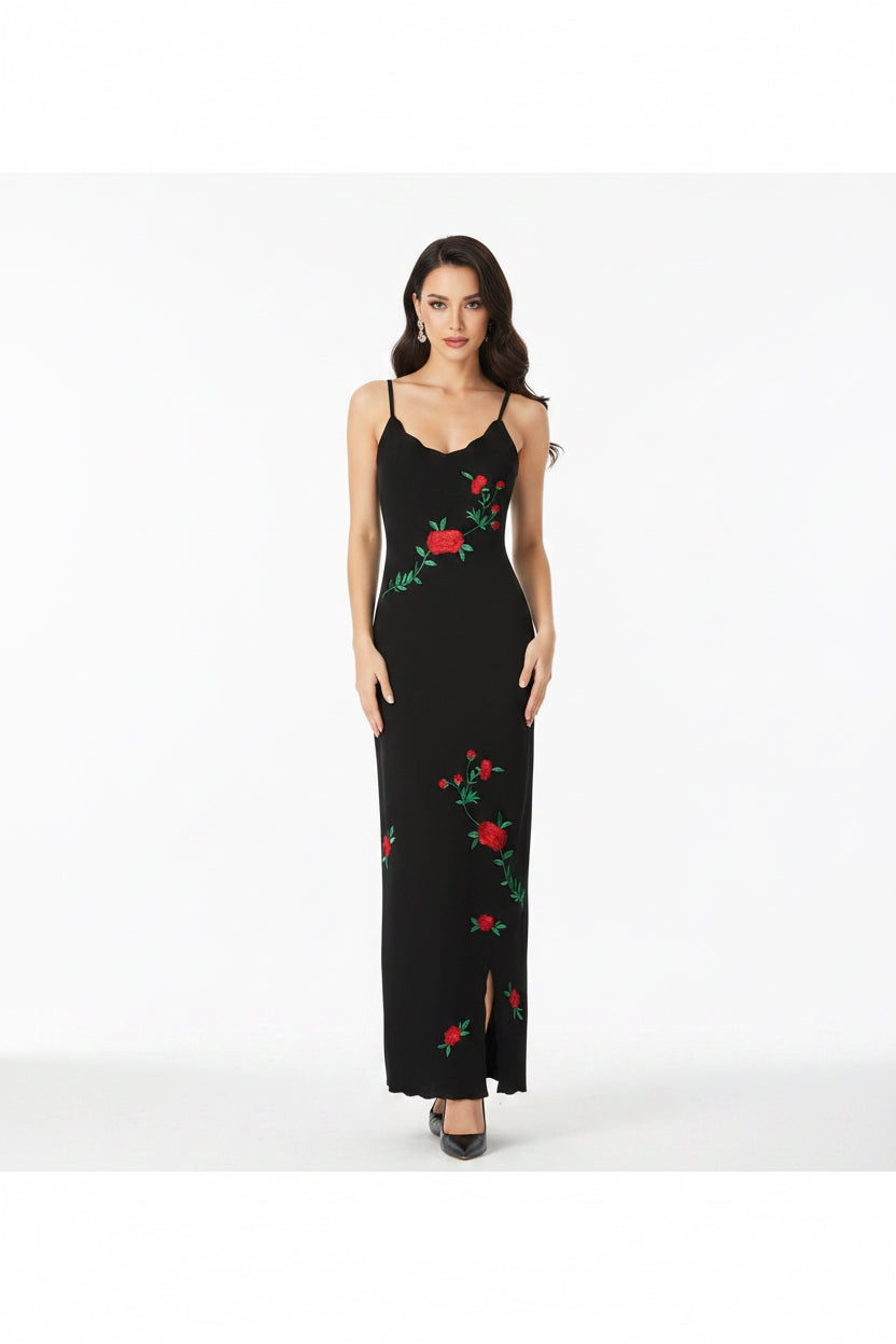 Black slip dress with floral embroidery on a white background
