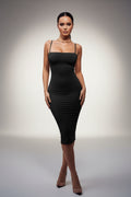 Woman wearing a black dress on a white background