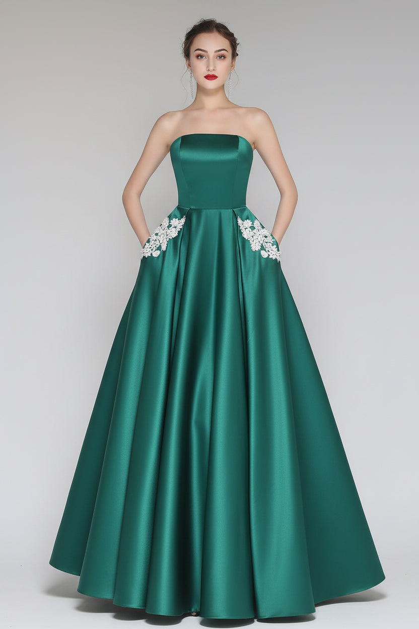 Green strapless gown with floral details on a gray background