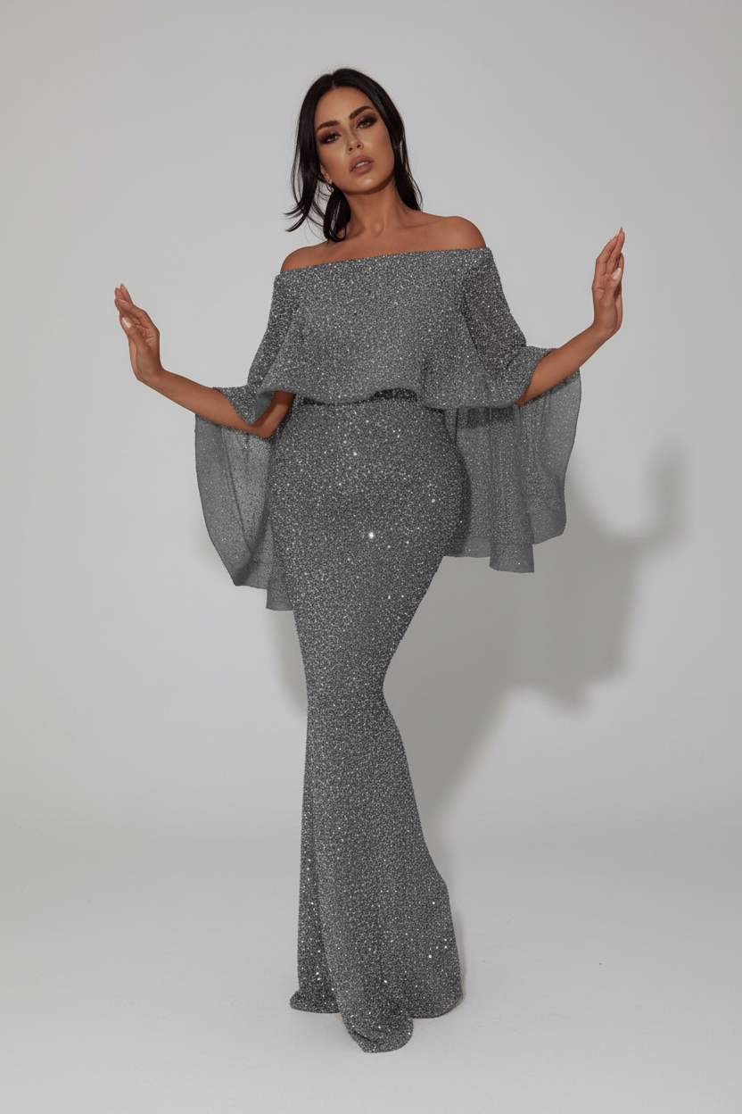 Woman wearing a sparkly silver off-shoulder outfit on a white background