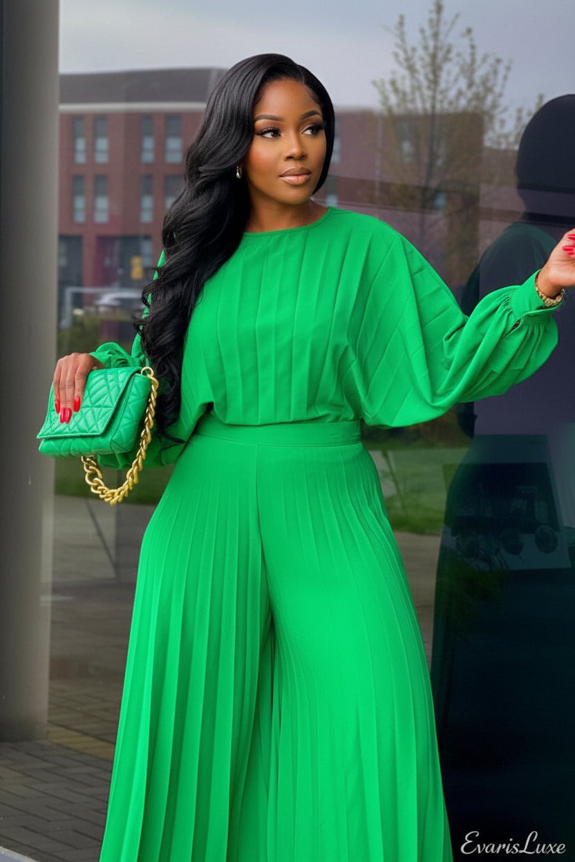 Woman in a bright green outfit holding a matching handbag at a bus stop.