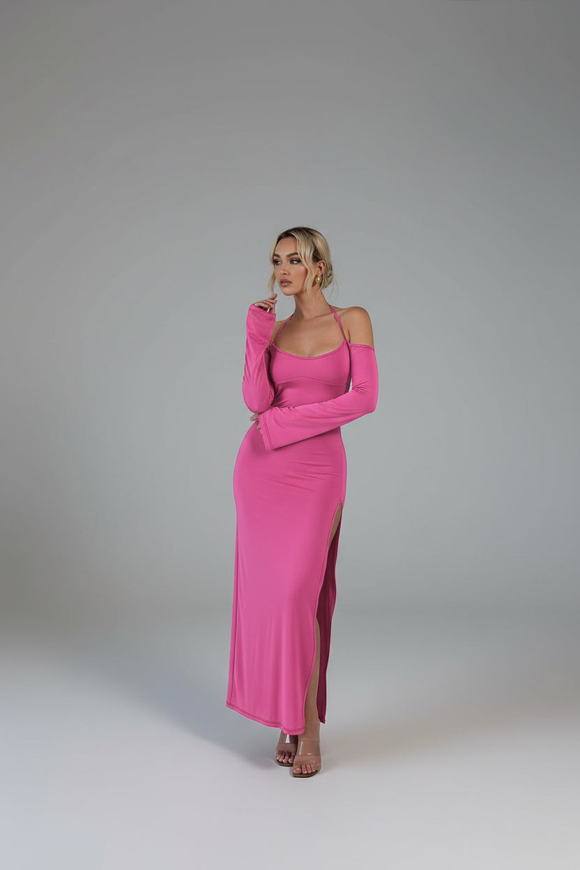 Woman in a pink dress standing in a modern kitchen.