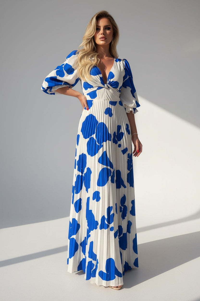Woman wearing a white dress with blue floral patterns on a white background