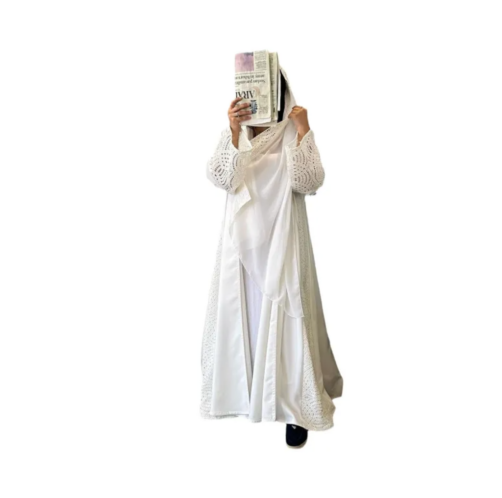 Person wearing a long white dress holding a newspaper over their face on a white background