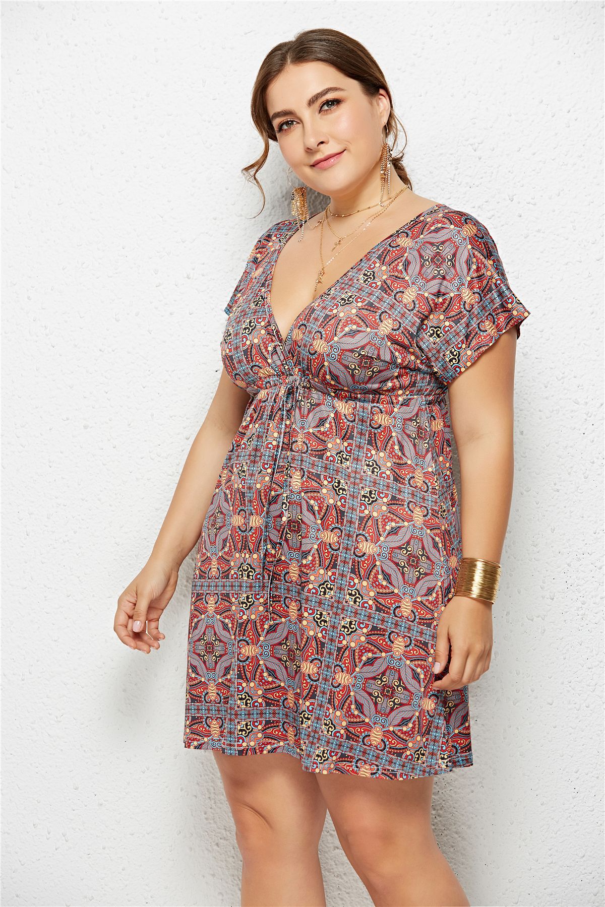 Woman wearing a patterned dress against a white background