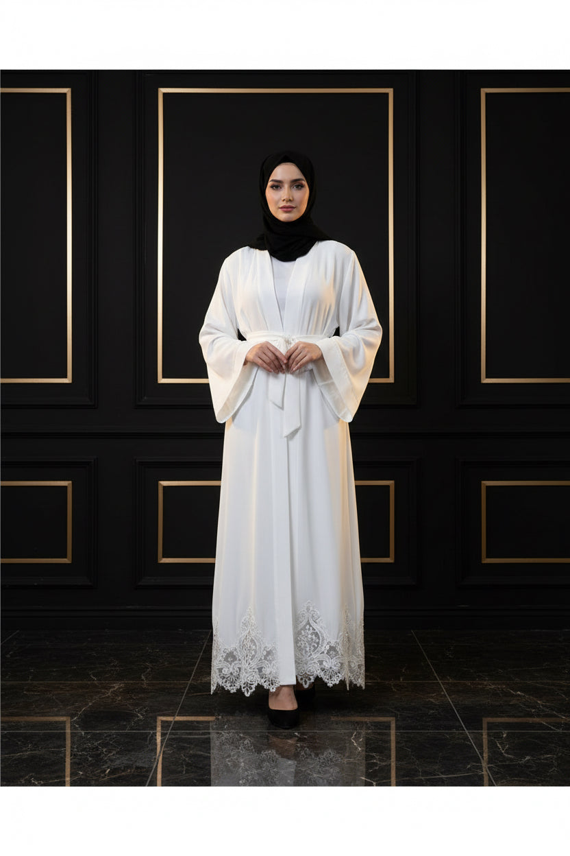 White lace-trimmed robe on a person against a white wall.