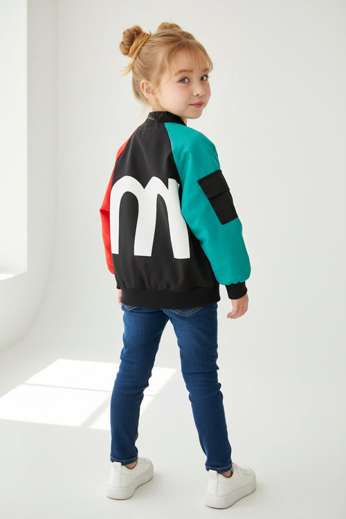 Colorful jacket with a large white letter 'm' on a textured surface