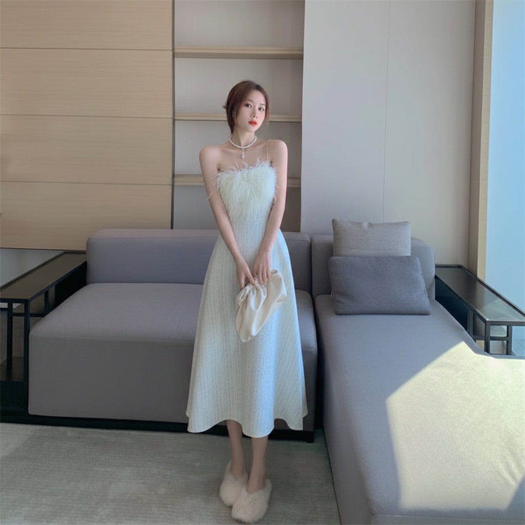 Woman in a white dress standing in a modern living room.