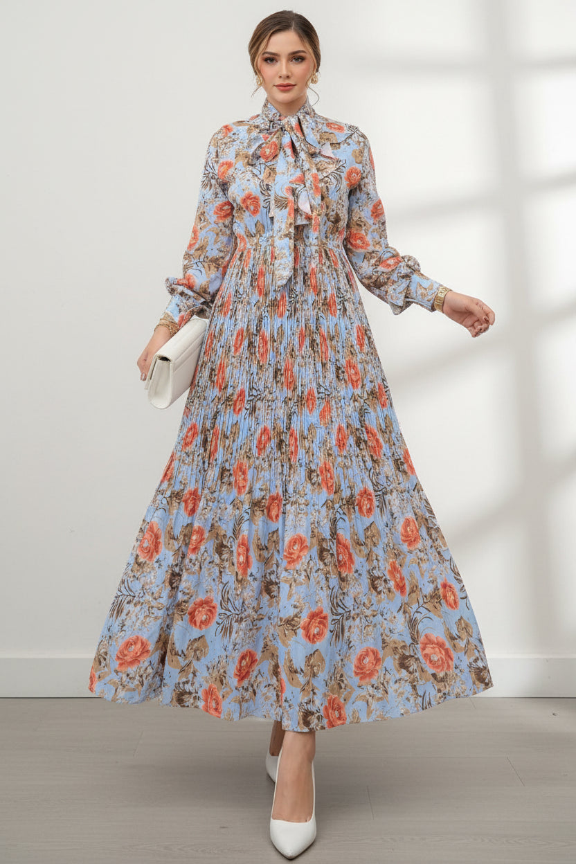 Woman wearing a floral dress with a close-up of the dress on a wooden floor.