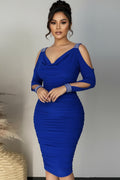 Blue dress with cut-out shoulders and matching gloves on a neutral background