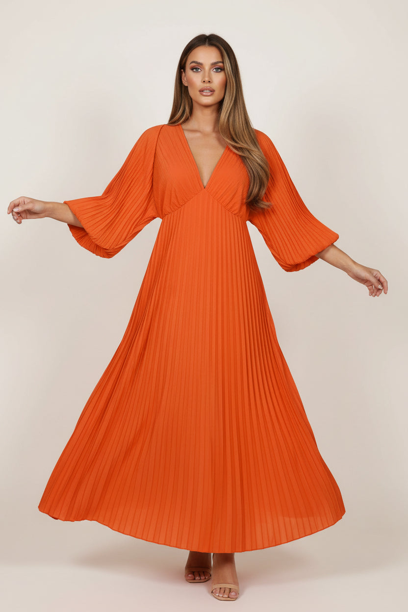 Orange pleated dress on a white background