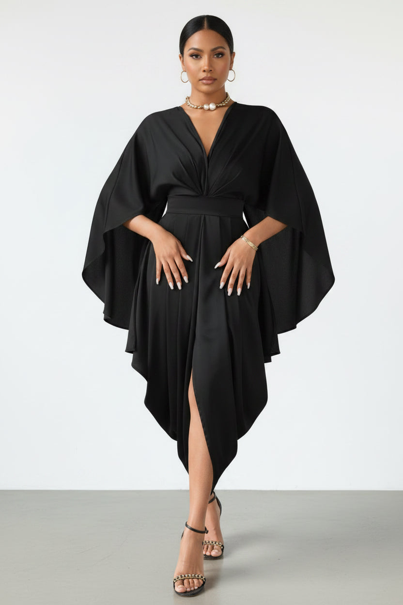 Person wearing a black dress with a draped design on a wooden floor.