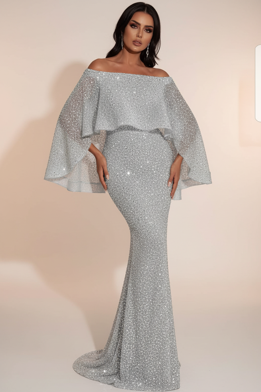 Woman wearing a silver off-shoulder gown in an elegant interior setting