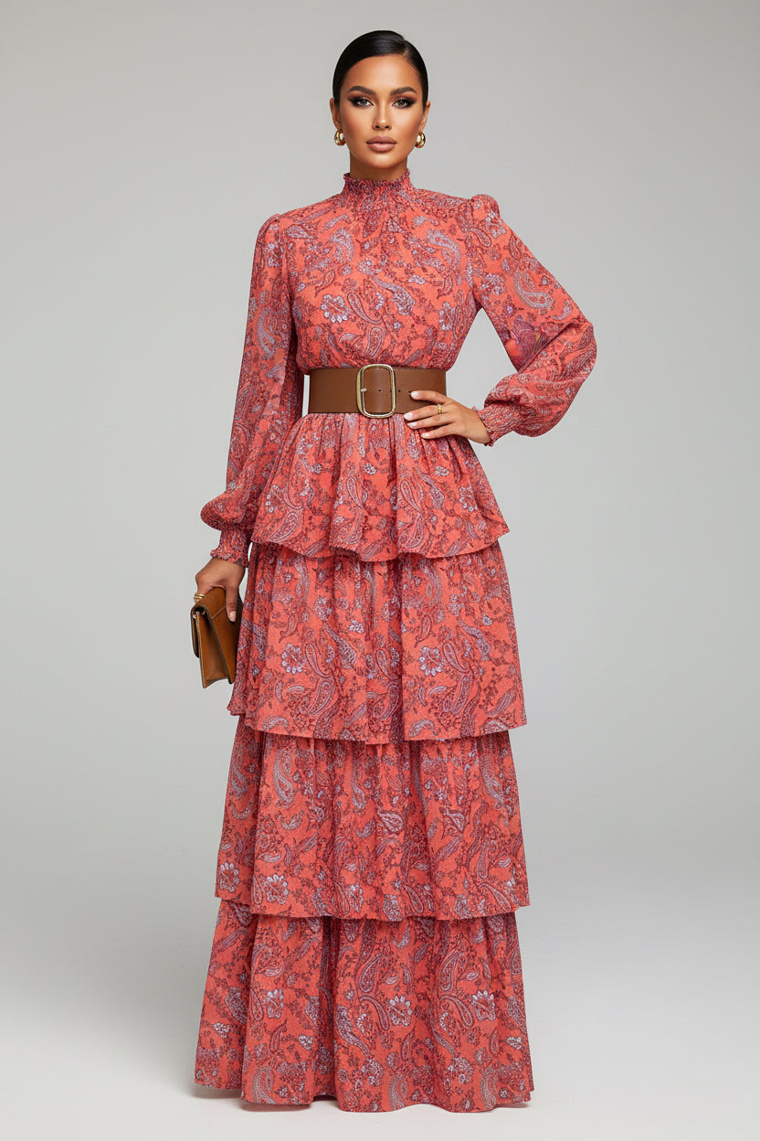 Person wearing a red patterned dress with a brown belt on a sidewalk.